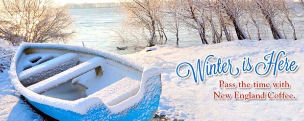 a blue row boat sitting on a bed of snow above an icy river